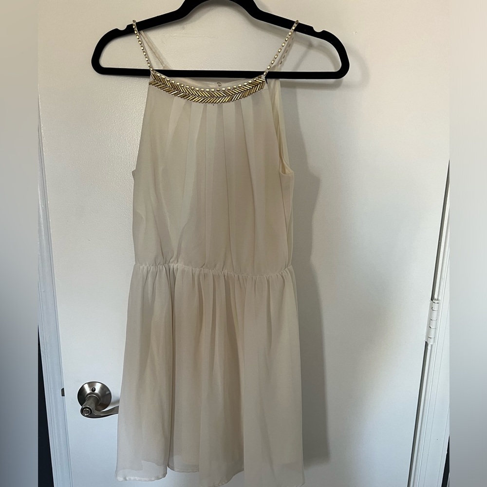 Beautiful cream colored dress with gold details. Only worn twice.